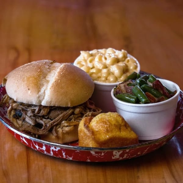 Cindy Lou's BBQ pulled pork sandwich with mac and cheese, green beans, and cornbread.